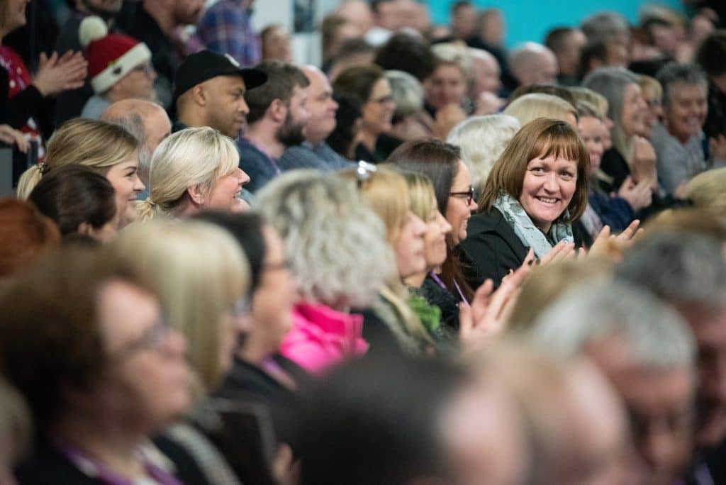 Staff applauding at a DN Colleges Group celebration event